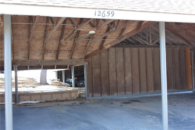 miscellaneous room featuring lofted ceiling and concrete flooring