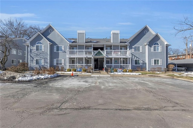 view of property with a balcony and covered porch