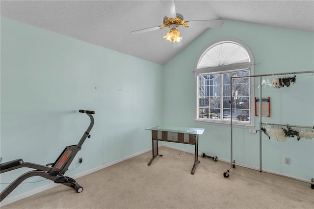 office area with vaulted ceiling, light colored carpet, a textured ceiling, and ceiling fan