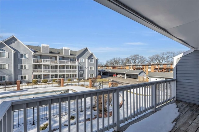 view of snow covered back of property