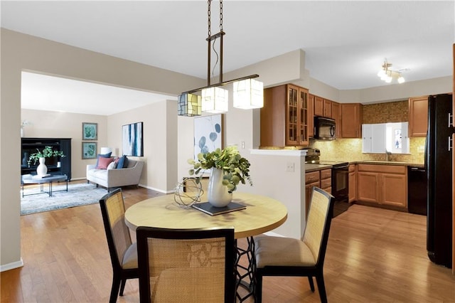 dining area featuring sink and light hardwood / wood-style flooring