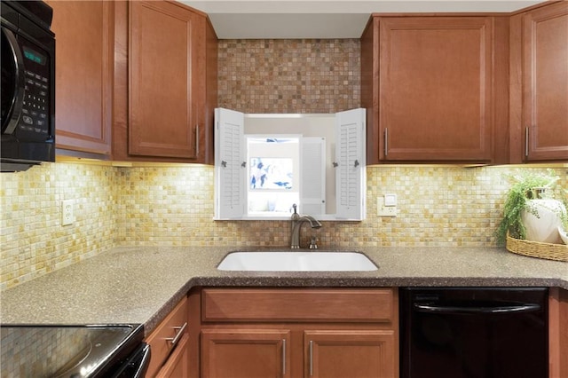 kitchen featuring sink, decorative backsplash, and black appliances