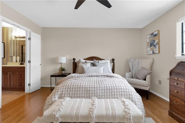 bedroom featuring ceiling fan, sink, connected bathroom, and light hardwood / wood-style floors