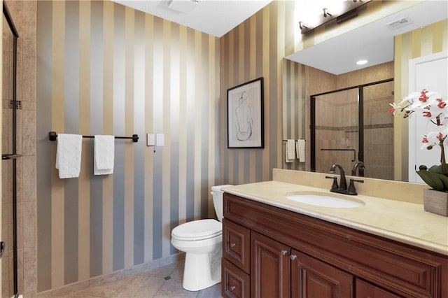 bathroom with vanity, toilet, an enclosed shower, and tile patterned flooring