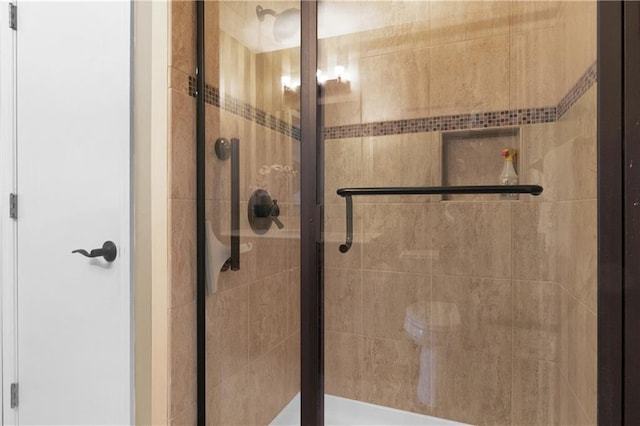 bathroom featuring a shower with door