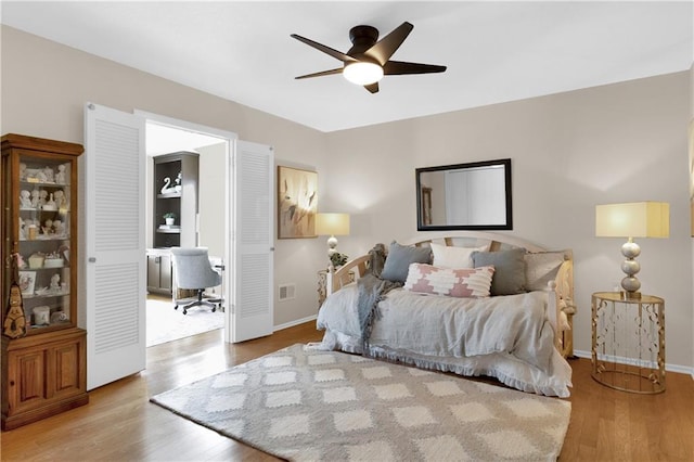 bedroom with ceiling fan and light hardwood / wood-style flooring