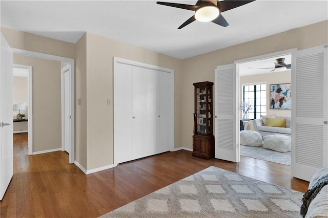 unfurnished bedroom featuring hardwood / wood-style flooring, ceiling fan, and a closet