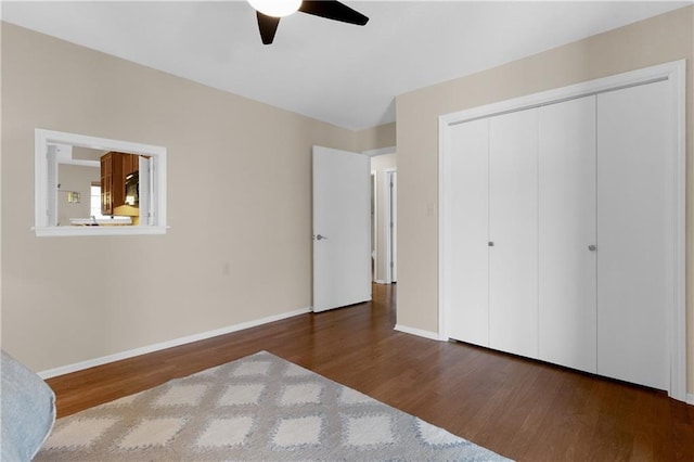 unfurnished bedroom with dark hardwood / wood-style floors, ceiling fan, and a closet