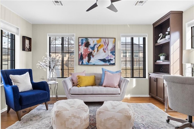 living area with light hardwood / wood-style flooring and ceiling fan