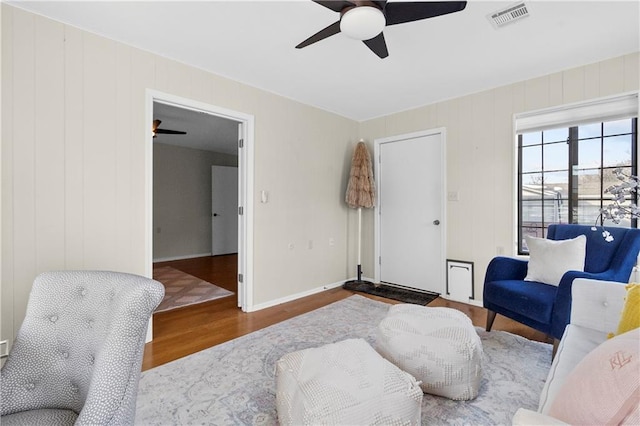 living room with hardwood / wood-style flooring and ceiling fan