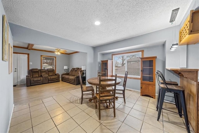 dining room featuring a ceiling fan, a textured ceiling, and light tile patterned floors