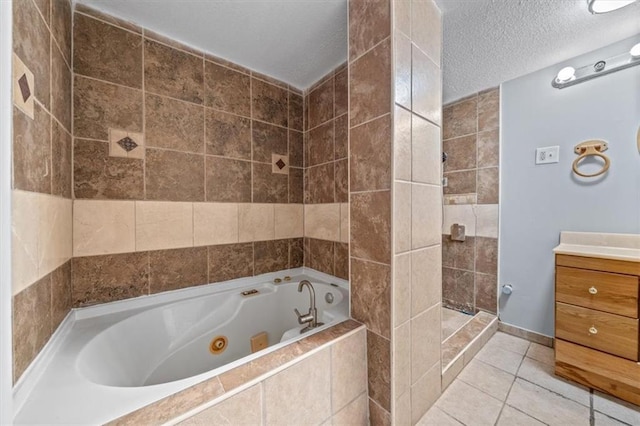 full bath featuring tile patterned floors, a jetted tub, a tile shower, a textured ceiling, and vanity