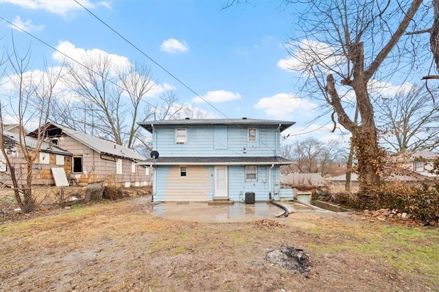 rear view of property featuring a patio and cooling unit