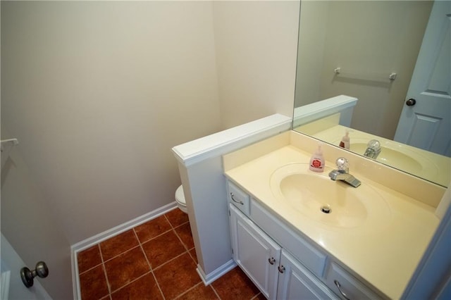 bathroom featuring vanity, tile patterned floors, and toilet