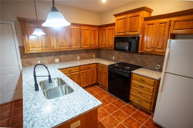 kitchen with sink, black appliances, pendant lighting, light stone countertops, and backsplash