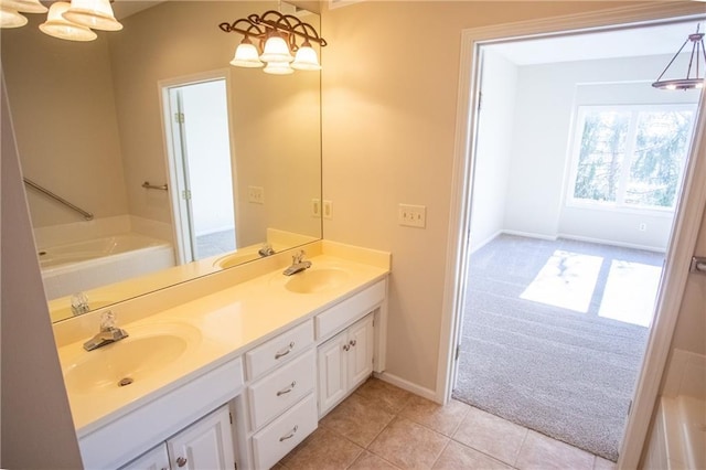 bathroom featuring vanity, tile patterned flooring, and a tub