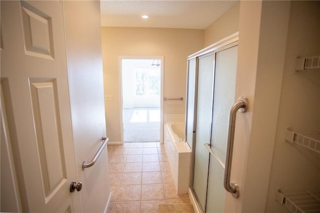 bathroom featuring tile patterned floors and separate shower and tub