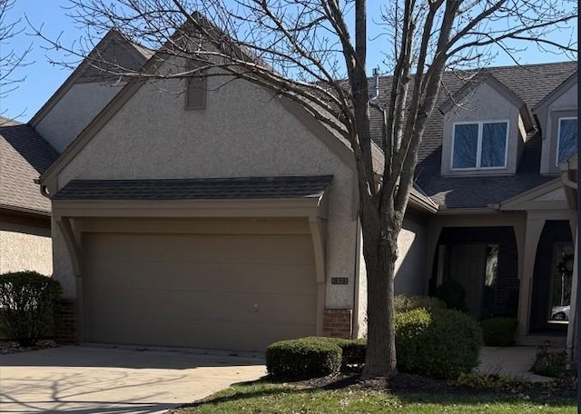 6323 W 145th St, Overland Park, KS 66223 - view of front of home featuring stucco siding, concrete driveway, a shingled roof, and a garage