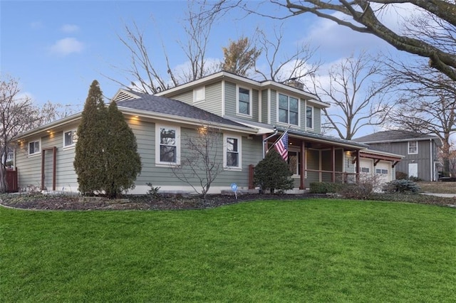 front of property with a garage, a front yard, and a porch