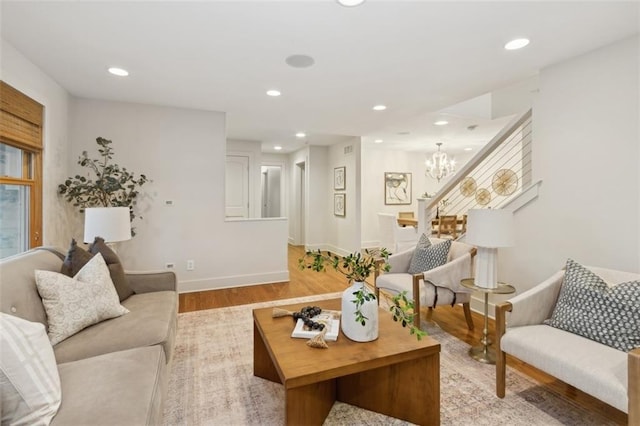 living room featuring an inviting chandelier and light wood-type flooring