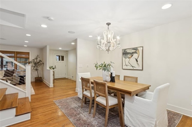 dining space featuring a chandelier and light hardwood / wood-style floors