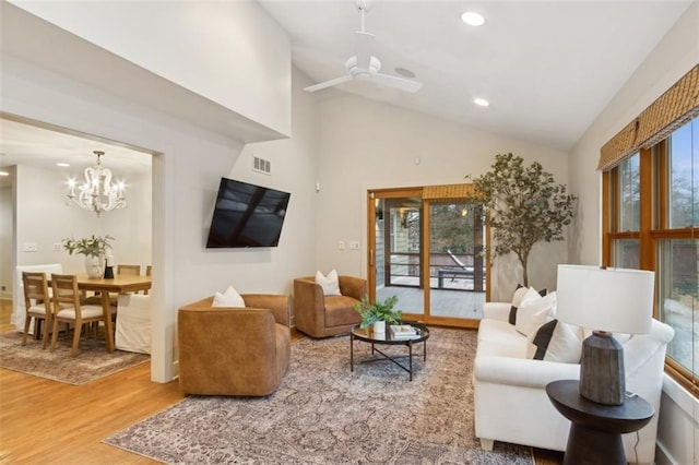 living room featuring lofted ceiling, hardwood / wood-style flooring, and a healthy amount of sunlight