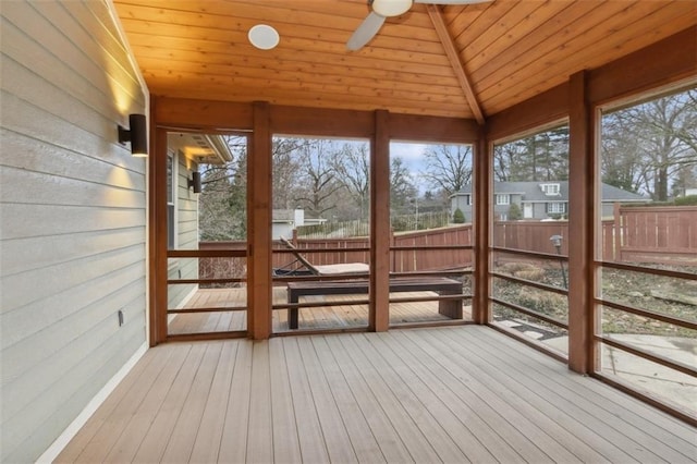 unfurnished sunroom featuring lofted ceiling, wooden ceiling, and ceiling fan