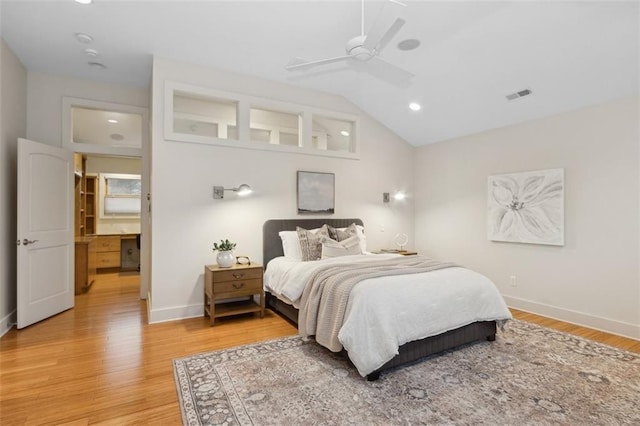 bedroom with hardwood / wood-style flooring, vaulted ceiling, and ceiling fan