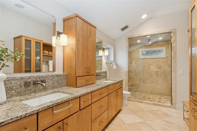 bathroom with tile patterned floors, lofted ceiling, toilet, an enclosed shower, and vanity