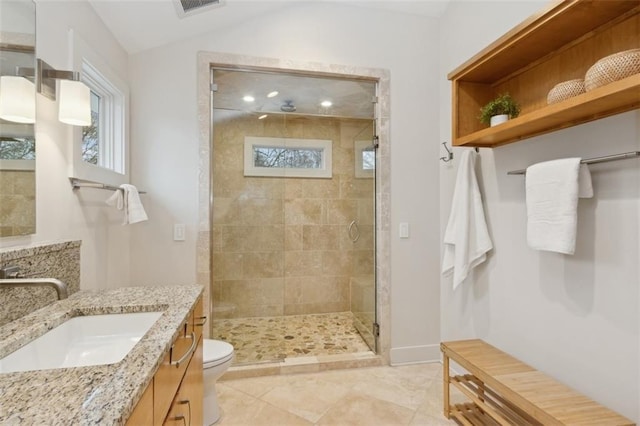 bathroom featuring lofted ceiling, vanity, a shower with door, and toilet