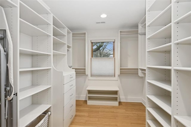 spacious closet featuring light hardwood / wood-style floors