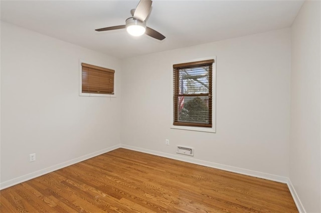 empty room with light hardwood / wood-style flooring and ceiling fan