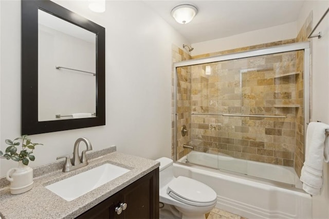 full bathroom with vanity, shower / bath combination with glass door, and toilet