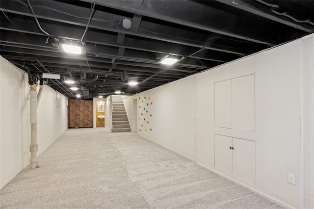 basement featuring light colored carpet