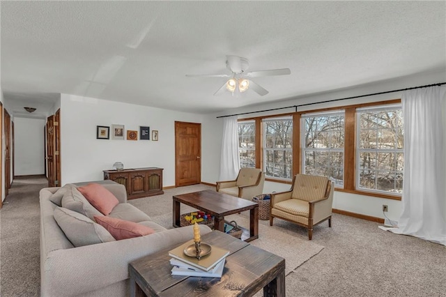 carpeted living room featuring ceiling fan and a textured ceiling