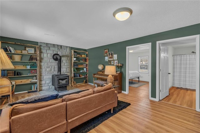 living room with wood-type flooring and a wood stove