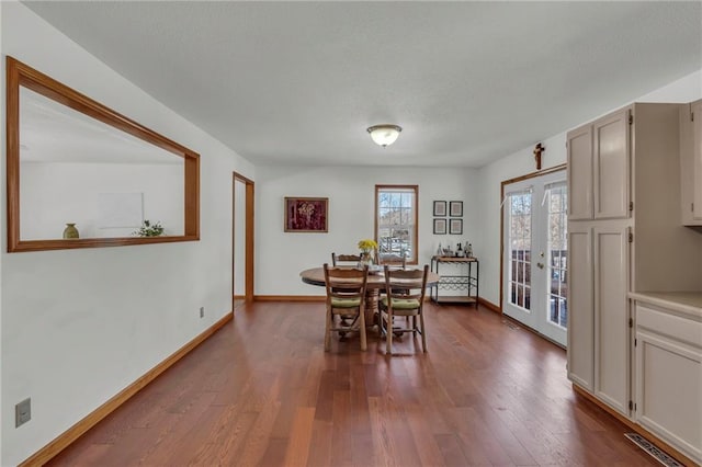 dining space with hardwood / wood-style floors and french doors