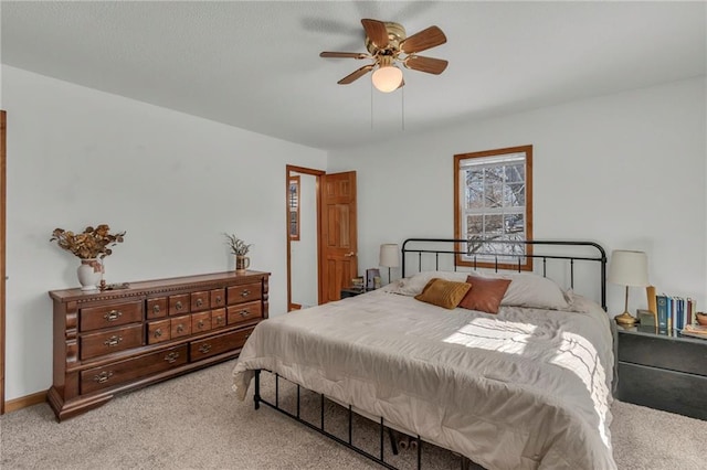 bedroom featuring light carpet and ceiling fan