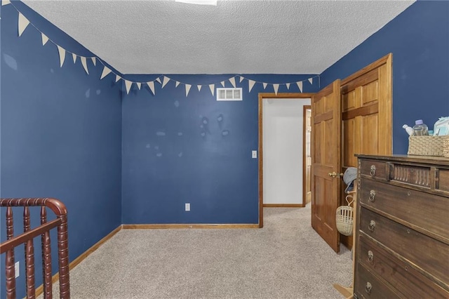 carpeted bedroom featuring a textured ceiling