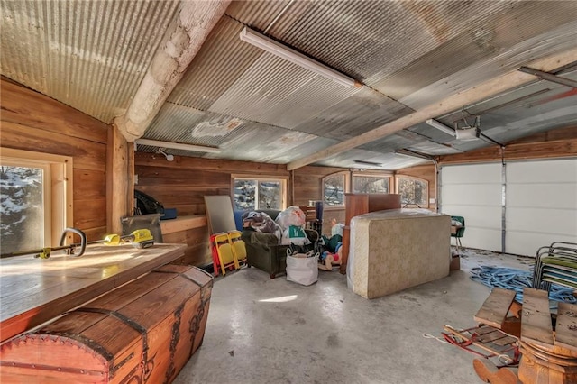 garage with a garage door opener and wooden walls