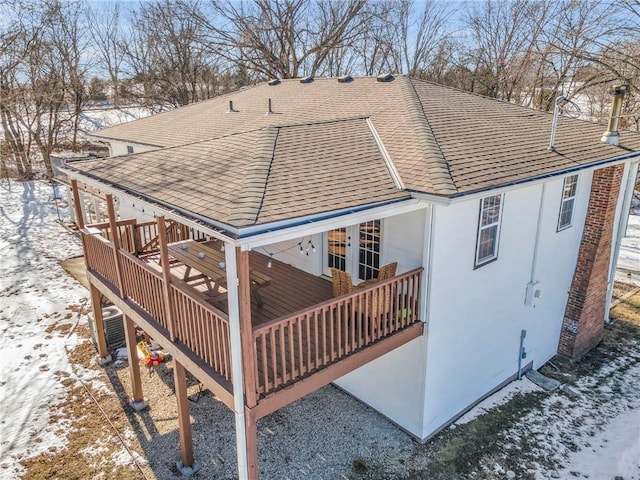 snow covered property featuring a wooden deck and central air condition unit