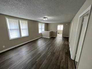 interior space featuring dark wood-type flooring and a textured ceiling