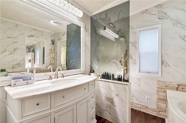 bathroom with vanity, wood-type flooring, ornamental molding, and tile walls