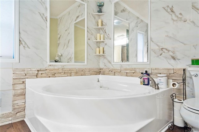 bathroom with wood-type flooring, ornamental molding, and toilet