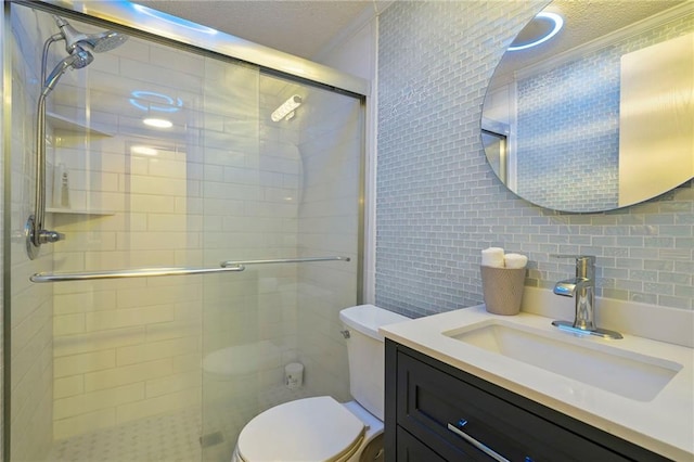 bathroom with vanity, ornamental molding, decorative backsplash, toilet, and walk in shower