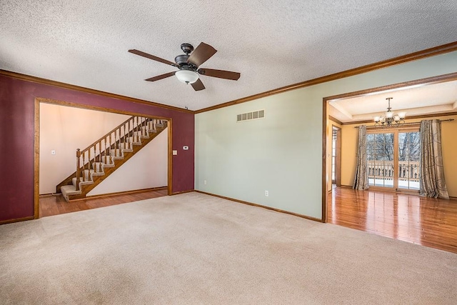 unfurnished living room with carpet floors, ornamental molding, and a textured ceiling