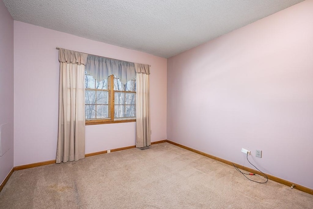 carpeted spare room with a textured ceiling