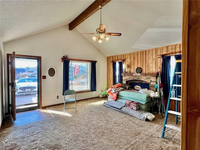 bedroom featuring ceiling fan, wooden walls, multiple windows, and a textured ceiling