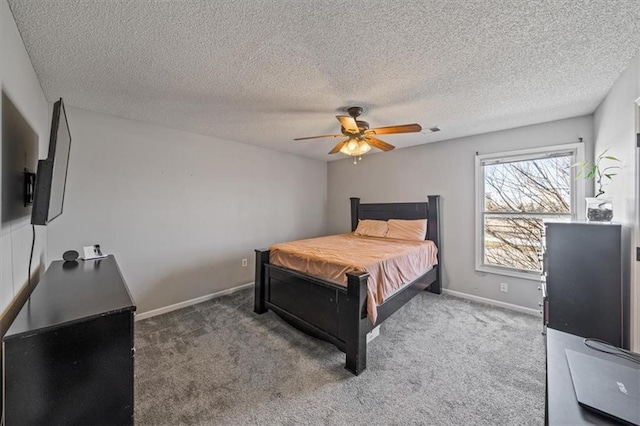 bedroom with carpet flooring, a textured ceiling, and ceiling fan