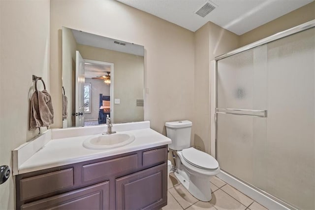 bathroom with walk in shower, vanity, toilet, and tile patterned flooring